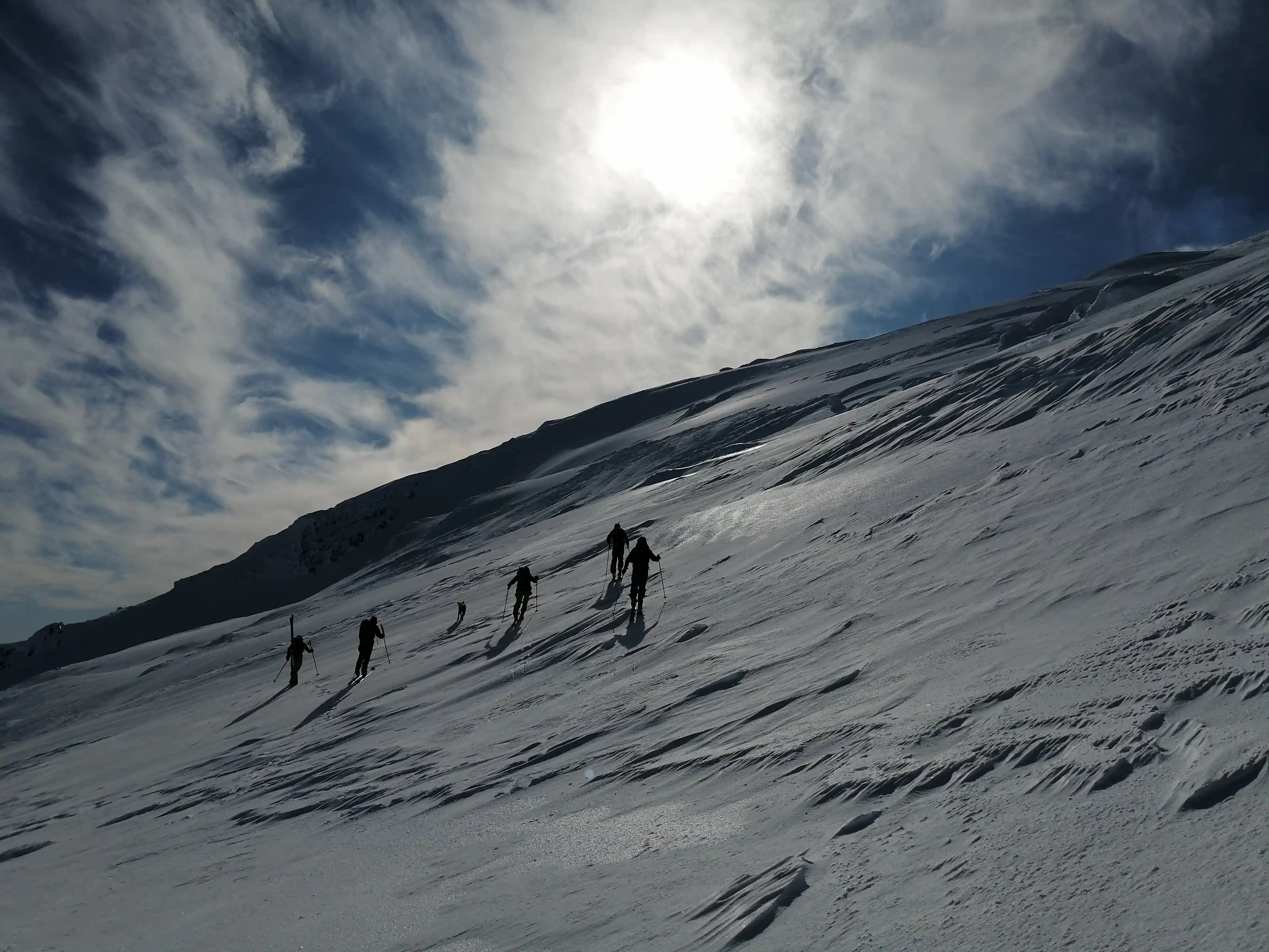 Hikers ascending the snow-covered slopes of Villarrica Volcano, Chile